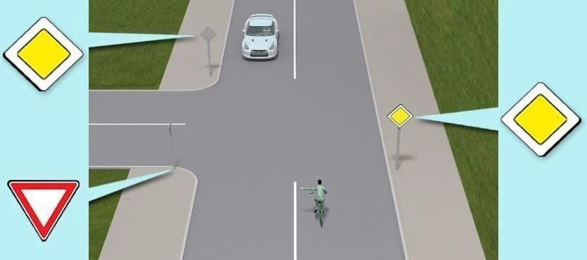 Ілюстрація до питання: Як велосипедист, що повертає ліворуч, проїде дане перехрестя?